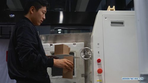 An employee works on 3D-printed pottery craftworks in Jingdezhen, east China's Jiangxi Province, Oct. 19, 2016. (Photo/Xinhua)