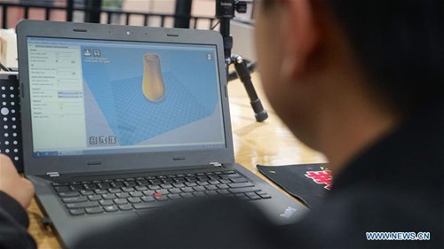 An employee works on 3D rendering to print pottery craftwork in Jingdezhen, east China's Jiangxi Province, Oct. 19, 2016. (Photo/Xinhua)