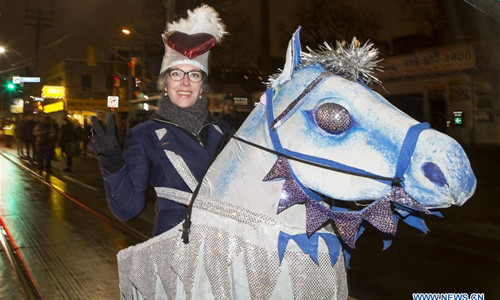 A reveller takes part in the 2016 Kensington Market Winter Solstice Festival in Toronto, Canada, Dec. 21, 2016. With lanterns, fire and unique performances, the Toronto's traditional event celebrated the longest night of the year on Wednesday. (Xinhua/Zou Zheng)