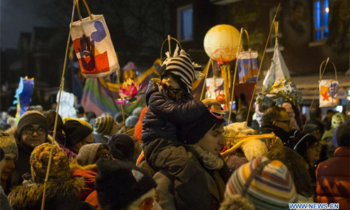 People take part in the 2016 Kensington Market Winter Solstice Festival in Toronto, Canada, Dec. 21, 2016. With lanterns, fire and unique performances, the Toronto's traditional event celebrated the longest night of the year on Wednesday. (Xinhua/Zou Zheng)