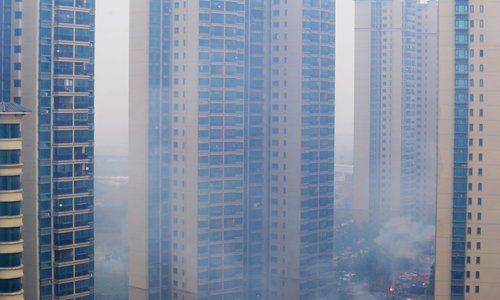 Billows of smoke surround residential buildings during Spring Festival in Hefei. Photo: IC