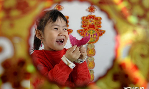 A young girl eats radish to celebrate Lichun, literally the beginning of spring in Chinese, at a kindergarten in Xingtai City, north China's Hebei Province, Feb. 3, 2017. Lichun, the first of the 24 solar terms, fell on Feb. 3 this year. Chinese usually eat radishes or spring pancakes to celebrate the day. (Xinhua/Mou Yu)