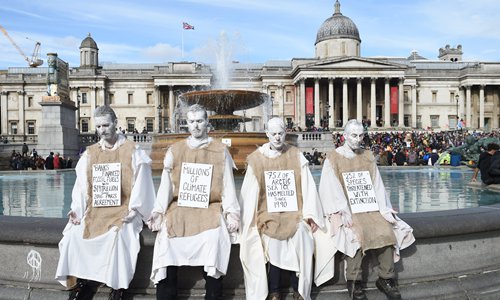 A crude performance: Semi-naked climate activists protest 