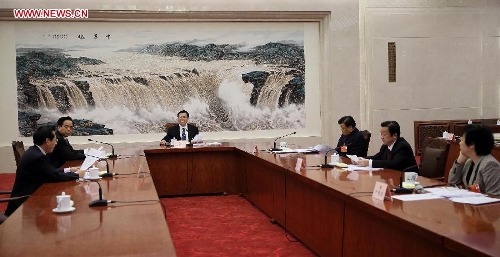 Zhang Dejiang (4th R), executive chairperson of the presidium of the first session of the 12th National People's Congress (NPC), presides over the third meeting of the presidium's executive chairpersons at the Great Hall of the People in Beijing, capital of China, March 12, 2013. (Xinhua/Lan Hongguang) 