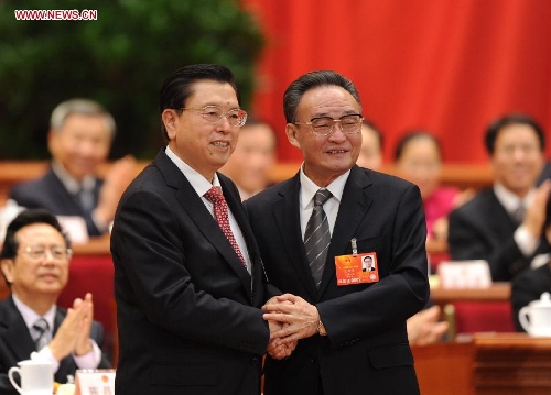 Wu Bangguo (R) shakes hands with Zhang Dejiang after Zhang was elected chairman of the 12th National People's Congress (NPC) Standing Committee at the fourth plenary meeting of the first session of the 12th NPC in Beijing, capital of China, March 14, 2013. (Xinhua/Xie Huanchi)