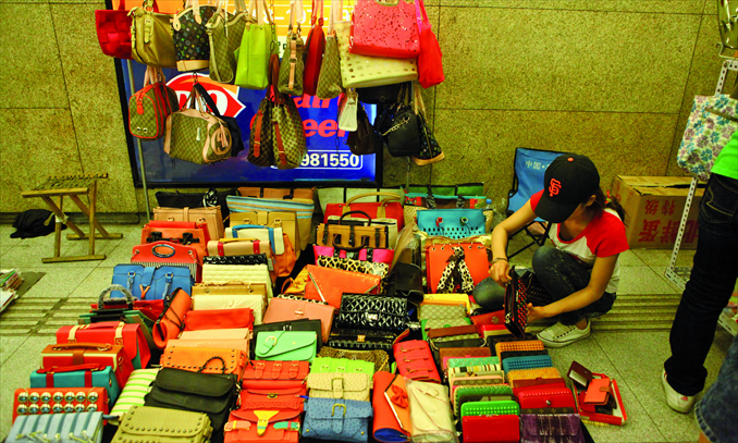 Fake brand handbags on sale in a subway passage in Beijing. Photo: Guo Yingguang/GT