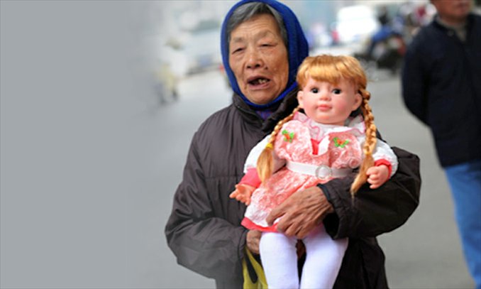 An elderly woman clutches a doll on the street in Jiaxing, Zhejiang Province. Photo: CFP
