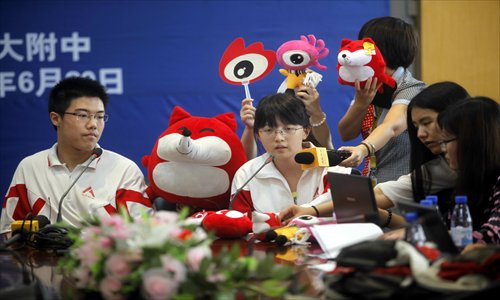Beijing’s highest-scoring students in the 2012 gaokao, Li Ze (left) and Han Mucen, both from the high school affiliated with the Renmin University of China, are interviewed by reporters on June 23. Photo: CFP