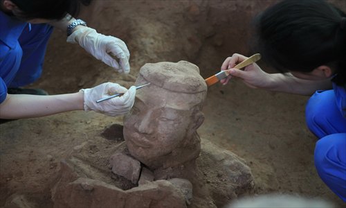 Archaeologists clean the newly unearthed terracotta warrior at the No.1 pit of the Museum of Terracotta Warriors and Horses of Qin Shihuang in Xi’an, Shaanxi Province, on Saturday. Photo:CFP