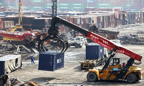Cranes move away destroyed containers at core area of Tianjin blasts