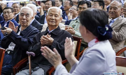 Li Zhong (2nd L, front), a 99-year-old alumnus of the National Southwest Associated University, a wartime union of universities which included Peking University (PKU), attends a ceremony marking the 120th anniversary of PKU at the Peking University Khoo Teck Puat Gymnasium in Beijing, capital of China, May 4, 2018. (Xinhua/Shen Bohan)