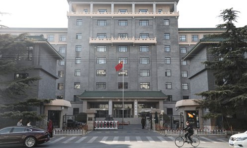 A man rides a bike past the National Development and Reform Commission in Beijing. Photo: VCG