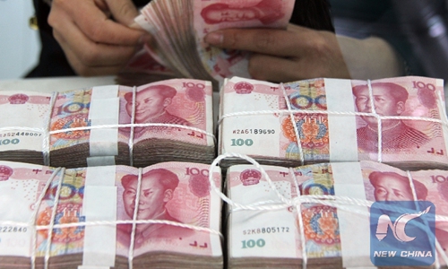 File Photo: A worker counts Chinese currency renminbi banknotes at a bank in Tancheng County of Linyi City, east China's Shandong Province, April 11, 2013. Photo:Xinhua
