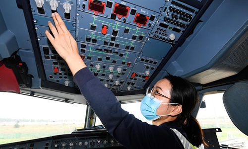 Maintenance engineer Lin Chunyan checks an airplane at the Haikou Meilan International Airport in Haikou, south China's Hainan Province, March 6, 2020. Wu Zhenzhen and Lin Chunyan are the only two female maintenance engineers of a maintenance base of the China Southern Airlines in Haikou, who are in charge of the maintenance of aircraft electronics. Due to the outbreak of the novel coronavirus disease (COVID-19) and a large number of flights were canceled, they have become more busier in maintaining the airplanes than before. She and her colleagues will work hard to ensure that every plane parked here are in good condition and can be put into use at any time, Lin Chunyan said. (Xinhua/Yang Guanyu)