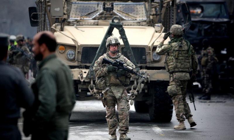 U.S. soldiers guard at the site of a suicide bombing in Kabul, Afghanistan, Feb. 26, 2015. At least two people were killed while several others wounded after a suicide bombing targeted the Turkish embassy's vehicles in front of the Iranian Embassy here on Thursday morning, sources said.Photo:Xinhua