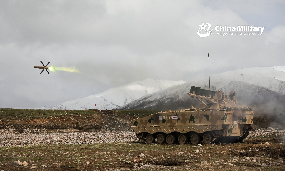 A tracked armored missile launching vehicle attached to a brigade under the PLA 76th Group Army launches anti-tank missile at a simulated target during a combined live-fire training exercise at the hinterland of the Kunlun Mountains in late June, 2020. (eng.chinamil.com.cn/Photo by Sun Wei)