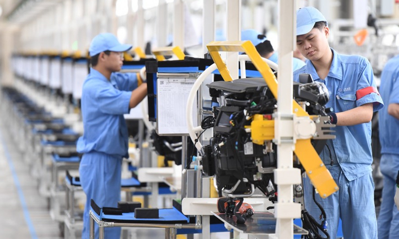 Workers assemble control system of instrument panel at a passenger car workshop of Ningde base of SAIC Motor Corporation Ltd. in Ningde, southeast China's Fujian Province, Sept. 15, 2020. (Xinhua/Song Weiwei)