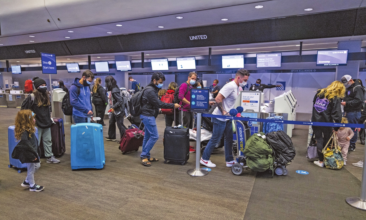 Passengers wearing protective masks check in at the San Francisco International Airport boarding area, in San Francisco, California, the US on Tuesday. Photo: VCG