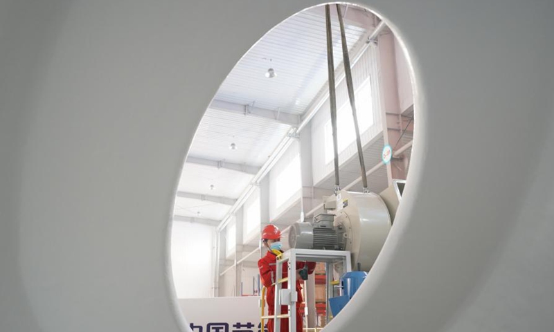 A worker adjusts a robot product in Xingtai City, north China's Hebei Province, March 5, 2021. In recent years, Xingtai Economic Development Area has taken the development of equipment manufacturing industry as an important strategic measure to drive the industrial transformation and upgrading of the whole region. Photo: Xinhua