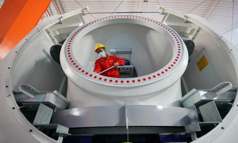A worker assembles parts of a wind turbine in Xingtai City, north China's Hebei Province, March 5, 2021. In recent years, Xingtai Economic Development Area has taken the development of equipment manufacturing industry as an important strategic measure to drive the industrial transformation and upgrading of the whole region. Photo: Xinhua