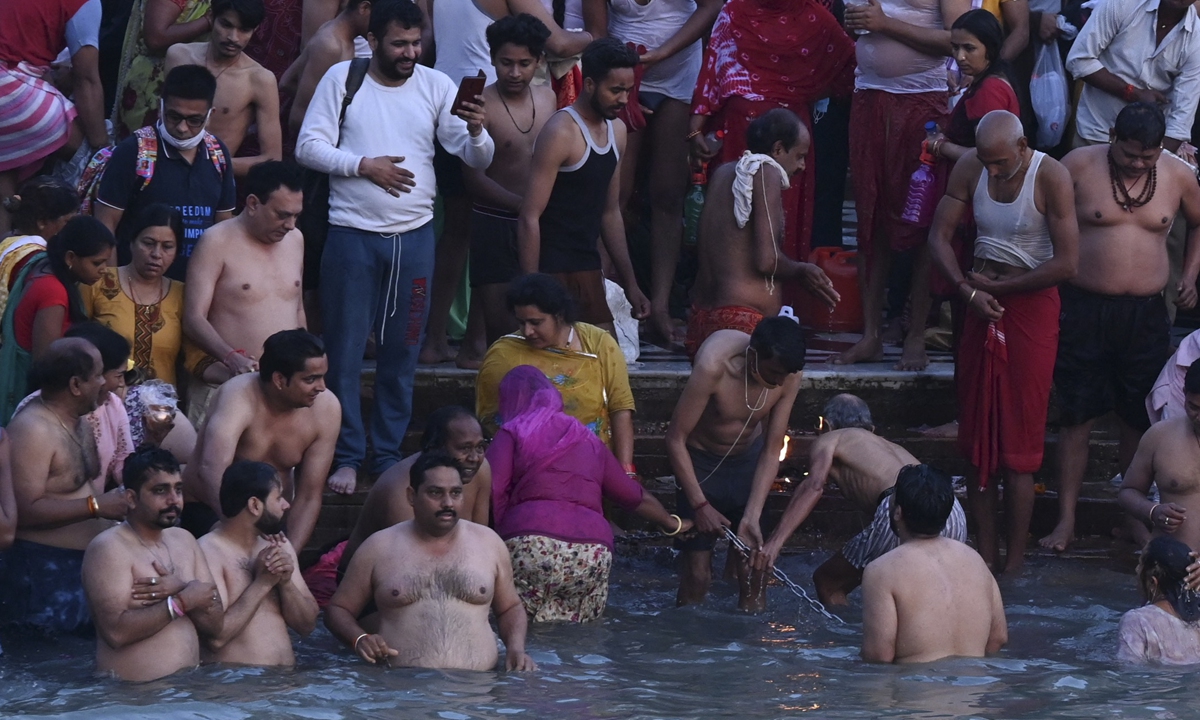 Hindu devotees take a holy dip in the waters of the River Ganges during the Kumbh Mela festival in Haridwar, India on Thursday. Photo: AFP