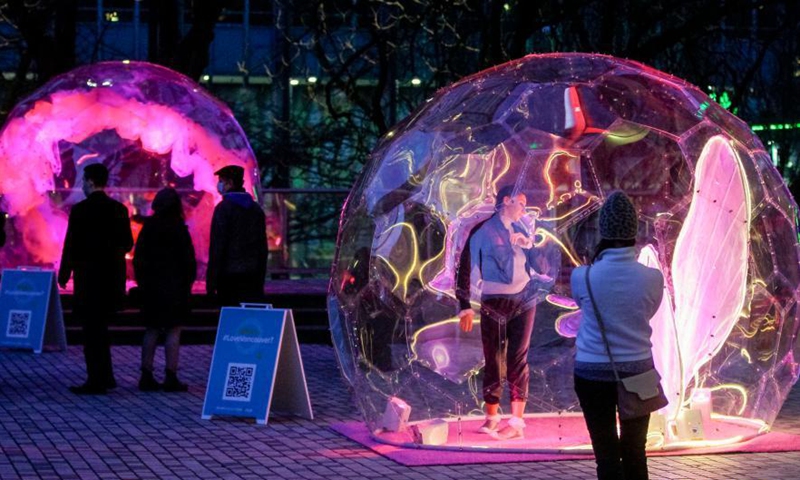 Dancers perform inside bubble installations during the Dance Bubbles show at Wall Centre Plaza in downtown Vancouver, Canada, March 12, 2021. The show features large brightly-lit bubbles with dancers inside and provides physically distanced entertainment for residents. Photo: Xinhua