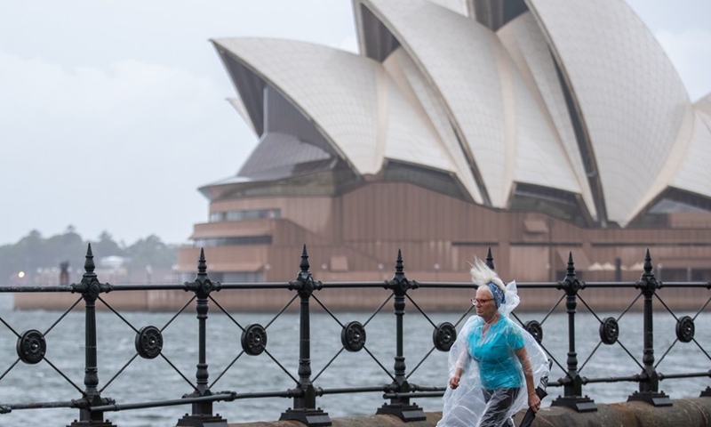A woman walks in the rain in Sydney, Australia, March 20, 2021.(Photo: Xinhua)