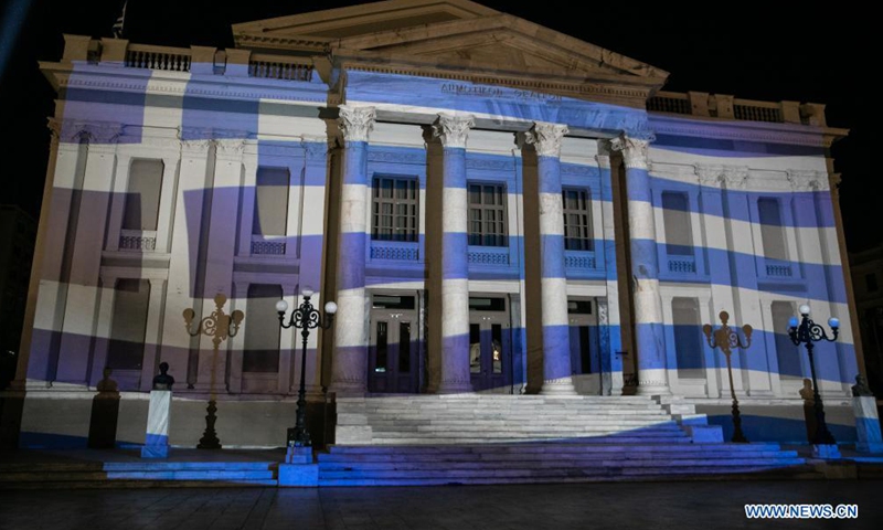 Photo taken on March 24, 2021 shows the Municipal Theatre of Piraeus illuminated with Greek flag 3D projection in Athens, Greece. Greece marked on Thursday the bicentennial of the start of the Greek War of Independence against Ottoman rule with a grand military parade in the center of Athens.Photo:Xinhua