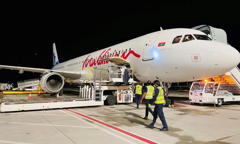 Photo taken with a mobile phone shows staff unloading China-aided COVID-19 vaccines at the Velana International Airport in Male, the Maldives, March 24, 2021. The first batch of vaccines against COVID-19 and anti-epidemic materials donated by China to the Maldives arrived Wednesday night and were handed over on Thursday. Photo:Xinhua