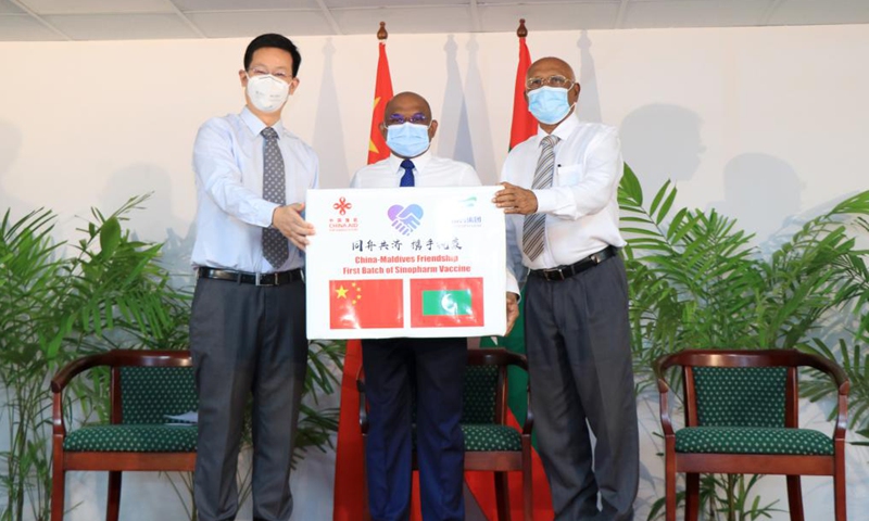 Chinese Ambassador to the Maldives Zhang Lizhong, Maldivian Foreign Minister Abdulla Shahid and Minister of Health Ahmed Naseem (From L to R) attend the handover ceremony in Male, the Maldives, March 25, 2021. The first batch of vaccines against COVID-19 and anti-epidemic materials donated by China to the Maldives arrived Wednesday night and were handed over on Thursday.Photo:Xinhua