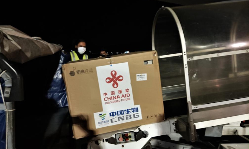 Photo taken with a mobile phone shows staff unloading China-aided COVID-19 vaccines at the Velana International Airport in Male, the Maldives, March 24, 2021. The first batch of vaccines against COVID-19 and anti-epidemic materials donated by China to the Maldives arrived Wednesday night and were handed over on Thursday.Photo:Xinhua