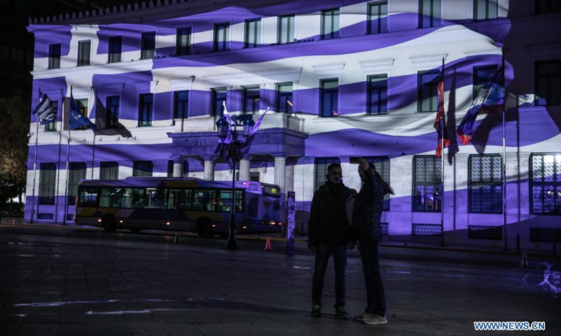 Photo taken on March 24, 2021 shows the City Hall of Athens illuminated with Greek flag 3D projection in Athens, Greece. Greece marked on Thursday the bicentennial of the start of the Greek War of Independence against Ottoman rule with a grand military parade in the center of Athens.Photo:Xinhua