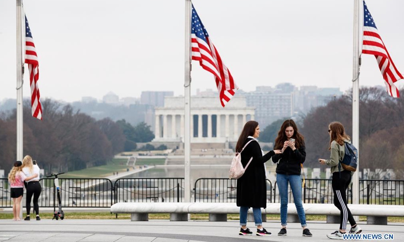 People gather near the Washington Monument in Washington, D.C., the United States, on March 25, 2021. U.S. President Joe Biden announced on Thursday a new goal of administering 200 million COVID-19 vaccine doses to Americans in his first 100 days in office.Photo:Xinhua