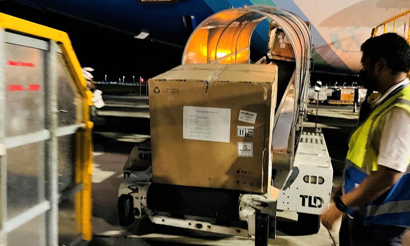 Photo taken with a mobile phone shows staff unloading China-aided COVID-19 vaccines at the Velana International Airport in Male, the Maldives, March 24, 2021. The first batch of vaccines against COVID-19 and anti-epidemic materials donated by China to the Maldives arrived Wednesday night and were handed over on Thursday. Photo:Xinhua