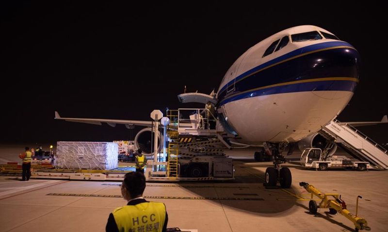 Staff members load Sinovac COVID-19 vaccines onto an airplane at Beijing Daxing International Airport in Beijing, capital of China, March 26, 2021. The first chartered international flight with 1.5 million Sinovac COVID-19 vaccines, which was operated by China Southern Airlines, heading for Phnom Penh, Cambodia departed Beijing Daxing International Airport on Friday. Photo:Xinhua