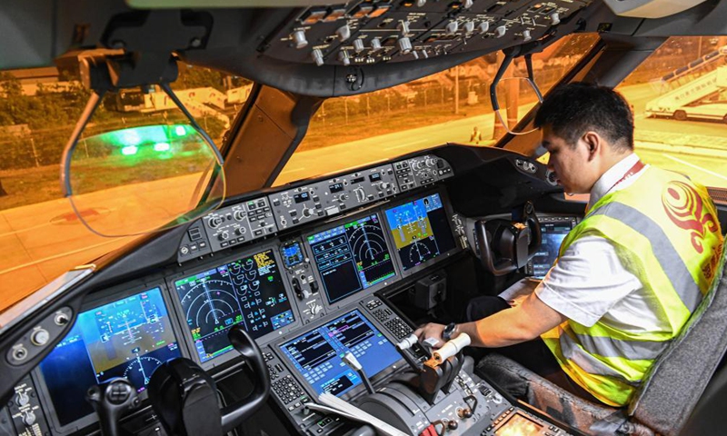 A crew member prepares the flight of a cargo plane of Hainan Airlines at Haikou Meilan International Airport in Haikou, south China's Hainan Province, March 26, 2021. China's southern tropical province of Hainan on Saturday launched a Haikou-Paris air freight route to serve international cargo transport of its free trade port. An outbound cargo flight carrying 35 tonnes of goods left Haikou for Paris on Saturday morning. Photo: Xinhua