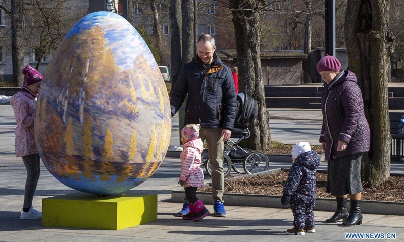 People look at an Easter egg decoration in Ogre, Latvia, on March 26, 2021.Photo:Xinhua
