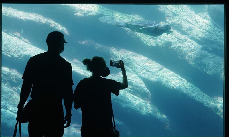 Tourists take pictures at the USHAKA Marine World in Durban, South Africa, April 1, 2021. Photo: Xinhua
