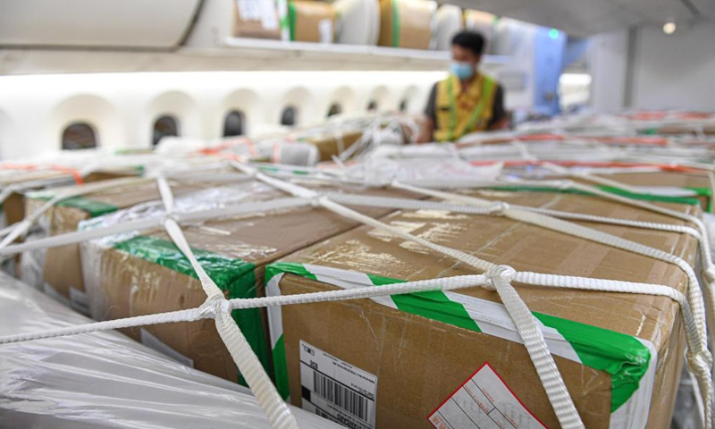 Goods are loaded on a cargo plane of Hainan Airlines at Haikou Meilan International Airport in Haikou, south China's Hainan Province, March 26, 2021. China's southern tropical province of Hainan on Saturday launched a Haikou-Paris air freight route to serve international cargo transport of its free trade port. An outbound cargo flight carrying 35 tonnes of goods left Haikou for Paris on Saturday morning. Photo: Xinhua
