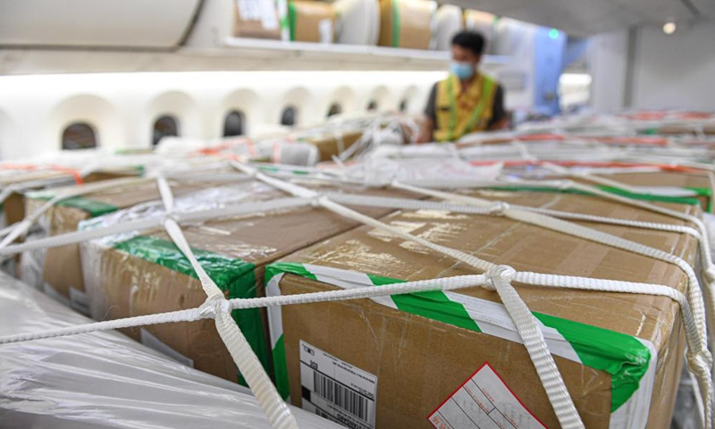 Goods are loaded on a cargo plane of Hainan Airlines at Haikou Meilan International Airport in Haikou, south China's Hainan Province, March 26, 2021. China's southern tropical province of Hainan on Saturday launched a Haikou-Paris air freight route to serve international cargo transport of its free trade port. An outbound cargo flight carrying 35 tonnes of goods left Haikou for Paris on Saturday morning.  Photo: Xinhua