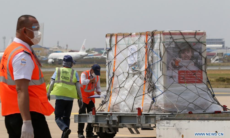 Airport workers transport a package of Sinovac COVID-19 vaccine at Phnom Penh International Airport in Phnom Penh, Cambodia, March 26, 2021. A new batch of COVID-19 vaccines Cambodia purchased from China's pharmaceutical company Sinovac Biotech arrived here on Friday, giving the country greater possibility to vaccinate its citizens against the virus.Photo:Xinhua