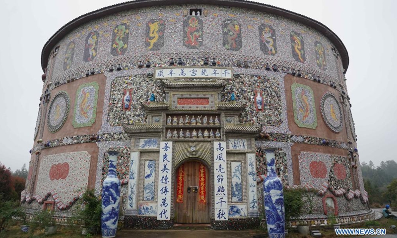 Tourists visit a porcelain palace in Xinping Village of Fuliang County in Jingdezhen, east China's Jiangxi Province, March 19, 2021. Yu Ermei, a 91-year-old villager who once worked in porcelain factory, started to build her porcelain palaces in Xinping Village from 2011. With her efforts, four buildings decorated with porcelain ware and porcelain pieces now stand in the village, attracting many tourists to visit.Photo:Xinhua