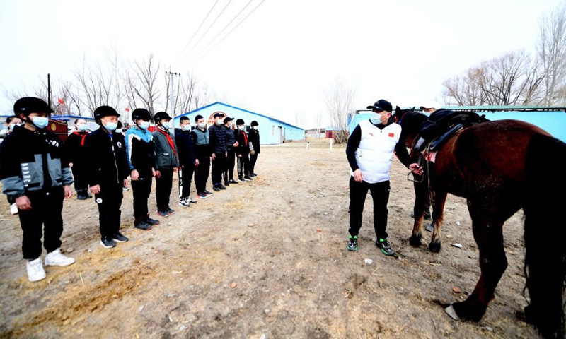 Equestrian coach Abduhyem Abduryem (R) explains knowledge to his students from Oymak Boarding School during an equestrian class in Burqin County, northwest China's Xinjiang Uygur Autonomous Region, March 29, 2021. Photo: Xinhua