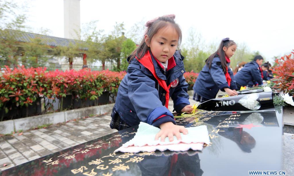 Primary school students pay tribute to martyrs at a cemetery in Huaying City, southwest China's Sichuan Province, April 1, 2021. The Tomb-sweeping Day, also known as Qingming Festival, which falls on April 4 this year, is a Chinese festival when people pay tribute to the dead and worship their ancestors by visiting tombs and making offerings. (Photo by Zhou Songlin/Xinhua)