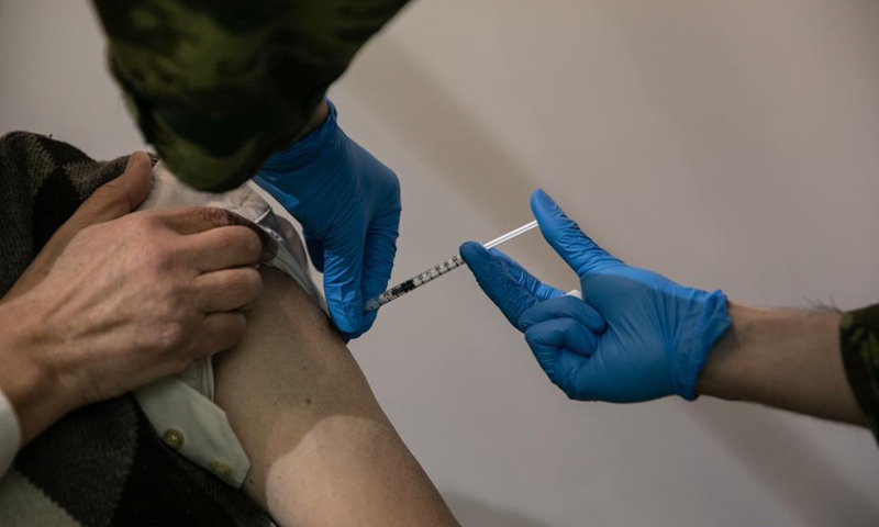A medical worker administers the COVID-19 vaccine at a vaccination center in Athens, Greece, on April 2, 2021. Greece will continue to administer AstraZeneca's COVID-19 vaccine despite the decision by some other European Union (EU) countries to suspend its use for certain age groups, Greek officials said on Friday. (Photo by Lefteris Partsalis/Xinhua)