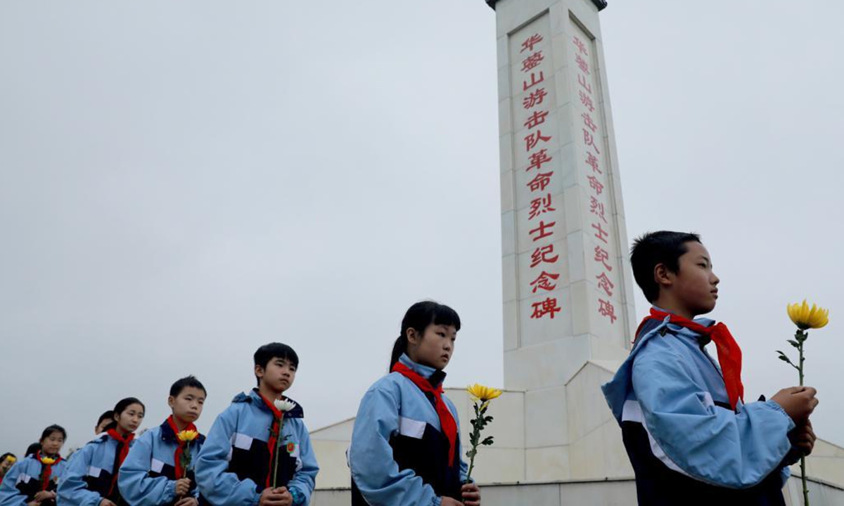 Primary school students pay tribute to martyrs at a cemetery in Huaying City, southwest China's Sichuan Province, April 1, 2021. The Tomb-sweeping Day, also known as Qingming Festival, which falls on April 4 this year, is a Chinese festival when people pay tribute to the dead and worship their ancestors by visiting tombs and making offerings. (Photo by Zhou Songlin/Xinhua)