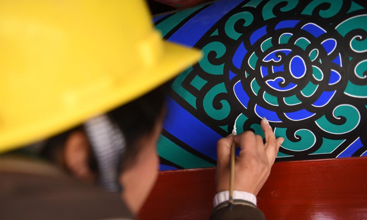 A worker repaints the colour of a royal tomb's building of the Western Qing Tombs in Yixian County, north China's Hebei Province, April 2, 2021. The maintenance and fixing of the Western Qing Tombs is underway in Yixian County of Hebei. (Xinhua/Zhu Xudong)