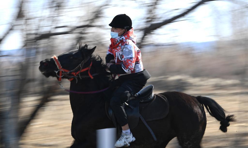 Parasat Zhumabek, a senventh grade student of Oymak Boarding School, rides a horse during an equestrian class in Burqin County, northwest China's Xinjiang Uygur Autonomous Region, March 30, 2021. Photo: Xinhua