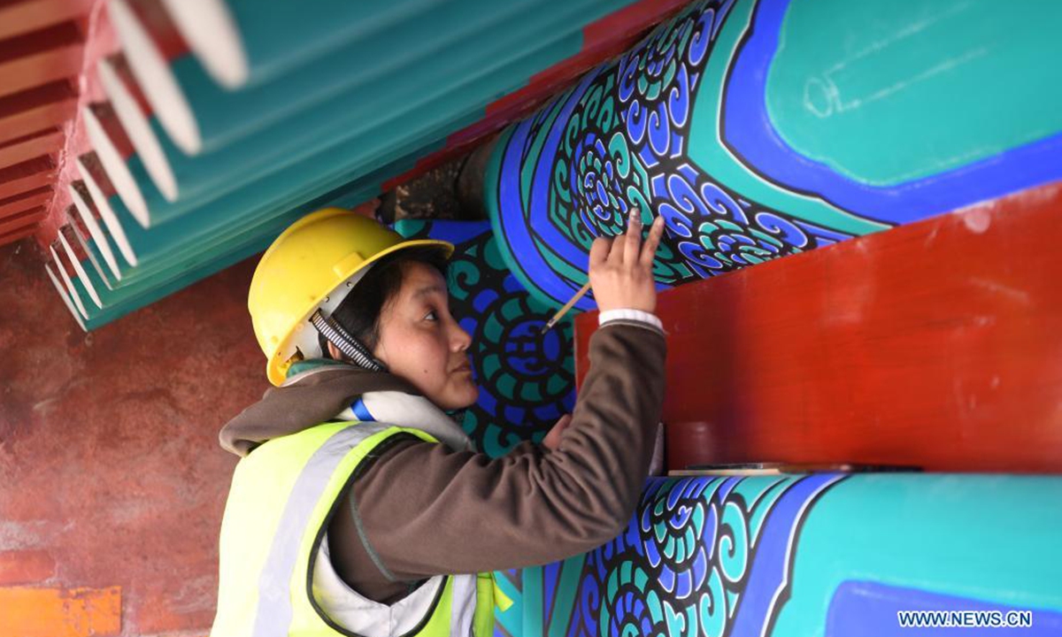 A worker repaints the colour of a royal tomb's building of the Western Qing Tombs in Yixian County, north China's Hebei Province, April 2, 2021. The maintenance and fixing of the Western Qing Tombs is underway in Yixian County of Hebei. (Xinhua/Zhu Xudong)