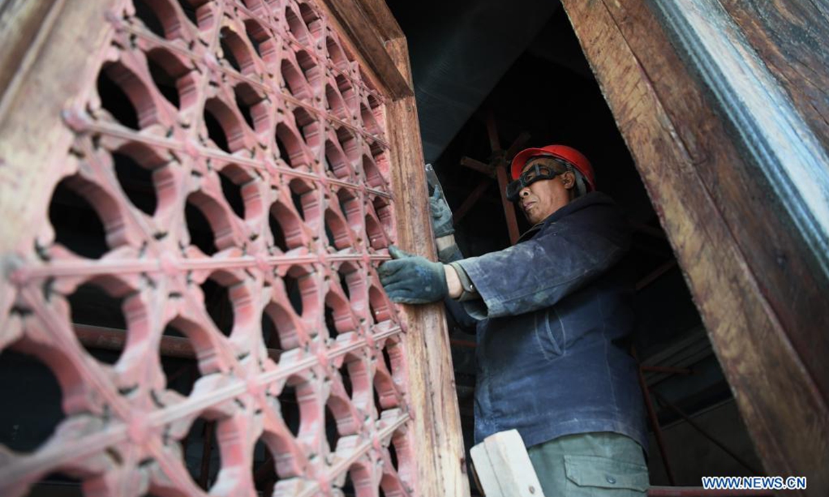 A worker repaints the colour of a royal tomb's building of the Western Qing Tombs in Yixian County, north China's Hebei Province, April 2, 2021. The maintenance and fixing of the Western Qing Tombs is underway in Yixian County of Hebei. (Xinhua/Zhu Xudong)